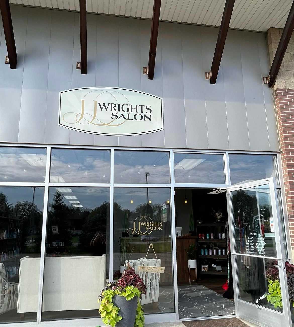 Exterior of J. Wright's Salon with glass facade and logo.